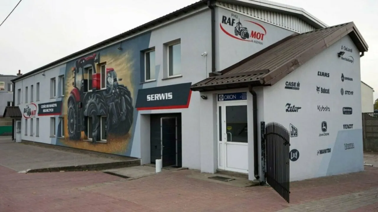 Wejście do serwisu RAF-MOT w Grajewie z muralem ciągnika